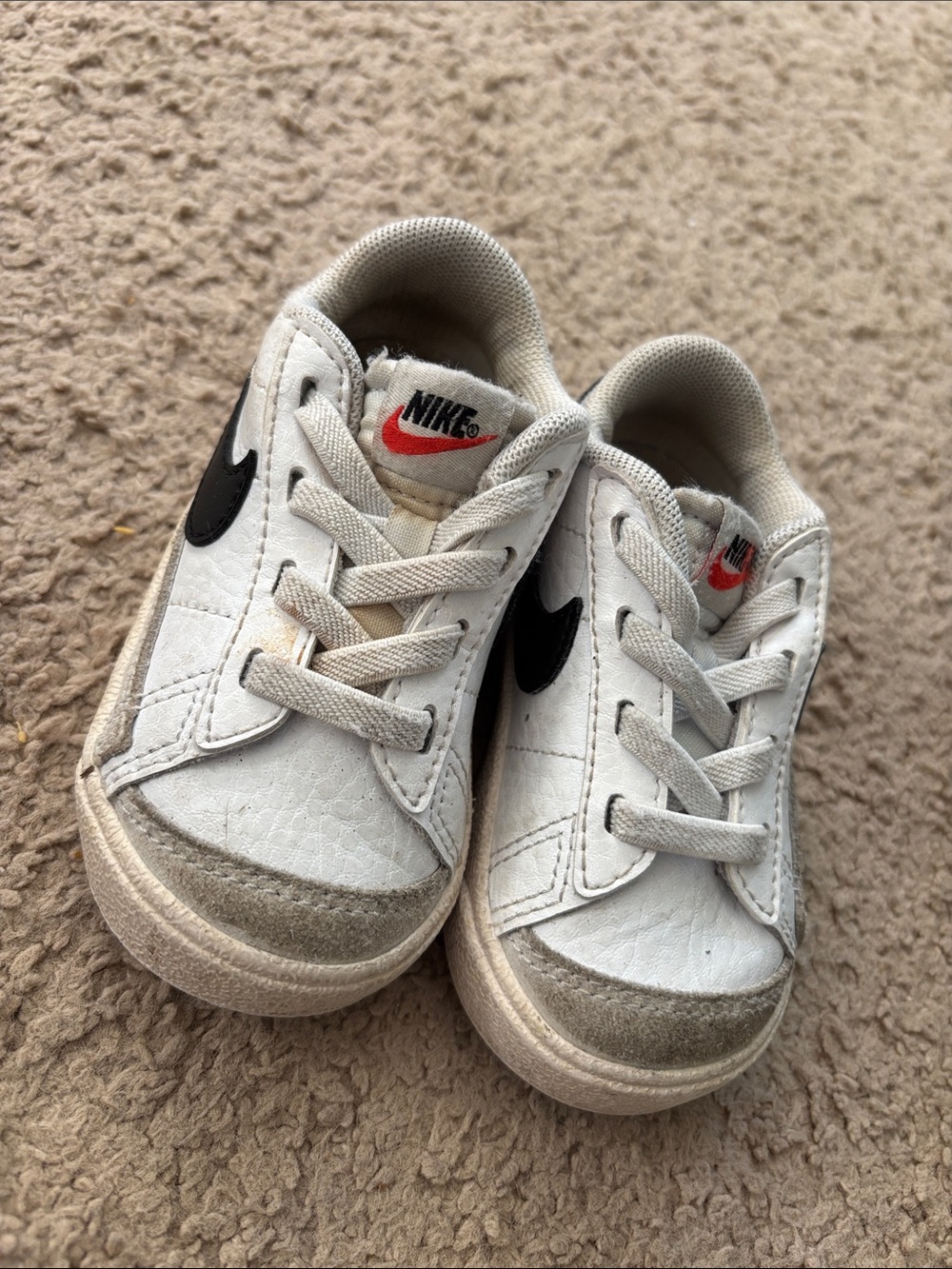 Nike Kids White Sneakers with Black Swoosh and Red Tongue Logo